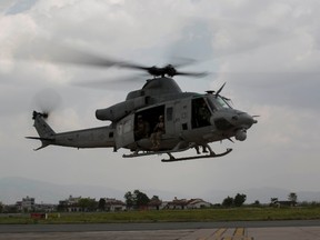 A UH-1Y Huey helicopter flies into the Tribhuvan International Airport after a search and rescue operation in Kathmandu, Nepal, May 13, 2015. A UH-1Y Huey assigned to Marine Light Attack Helicopter Squadron 469, carrying six Marines and two Nepalese soldiers, went missing while conducting humanitarian assistance after a 7.3 magnitude earthquake on May 12. It was later discovered that the Huey crashed in the mountains. REUTERS/Thor J. Larson/U.S. Marine Corps/Handout