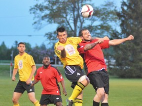 Forward Matt Ruby (right) of the Simcoe Thunder goes ‘head-to-head’ with a member of the Wallaceburg Sting as he head butts the ball during a Western Ontario Soccer League First Division match May 14, 2015 at the E&E McLaughlin Soccer Park in Delhi. In a close match Simcoe defeated Wallaceburg 3-2. (EDDIE CHAU Simcoe Reformer)