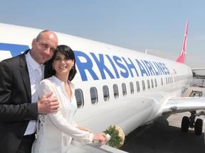 Vjera Mujovic and Stefan Preis pose for a photo after their wedding in mid-air on a Turkish Airlines flight last week. The Serbian actress and German doctor met a year before on the same flight and happened to be seated on seats right next to each other. (Postmedia Network/Turkish Airlines)