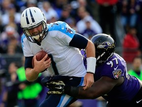 Quarterback Zach Mettenberger of the Tennessee Titans is sacked by defensive tackle Timmy Jernigan of the Baltimore Ravens during NFL play at M&T Bank Stadium November 9, 2014 in Baltimore. (Rob Carr/Getty Images/AFP)