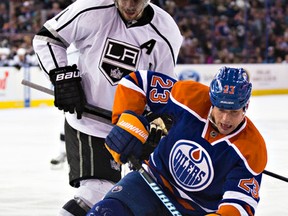 Edmonton's Matt Hendricks (23) battles off the faceoff with Los Angeles' Anze Kopitar (11) during the third period of the Edmonton Oilers' NHL hockey game against the Los Angeles Kings at Rexall Place in Edmonton, Alta., on Tuesday, April 7, 2015. The Oilers won 4-2. Codie McLachlan/Edmonton Sun/QMI Agency