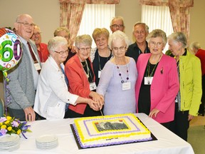 At their 60th anniversary/reunion at the Mitchell Golf and Country Club, members of the Stratford Teachers College class of 1955 organizing committee gathered together to cut the cake, complete with a picture of their old school emblazoned in the cake's icing. Back row (left): John Mann, Derek Nind, Shirley Nind, Betty Ross, Alex Seaton, Jack Rice, Isobel Rice. Front row (left): Nancy Kraemer, Marjory Thompson, Eileen Seaton, Shirley Lyle. GALEN SIMMONS/MITCHELL ADVOCATE