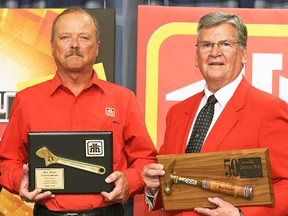 Ken Faust (left), accepts the Golden Hammer Award for 50 years of service, from Paul Strauss, of Home Hardware, at the company's twice-yearly buying market and shareholders meeting in St. Jacobs April 20. SUBMITTED PHOTO