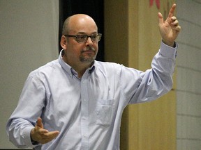 Donald Prong, executive director of the Ontario Association of the Deaf, gestures and signs as he presents to Holy Trinity students. 
(Tyler Kula, The Observer)