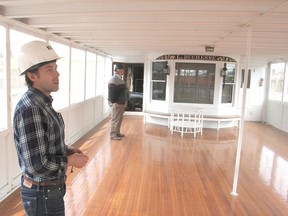 Emmett Smith, left, curator of the Antique Boat Museum in Clayton, N.Y., which owns La Duchesse, and Tom Wroe, president of MetalCraft Marine, where the vessel is now drydocked, look through a lounge on board the houseboat, which was built in 1903. MAY 15, 2015 KINGSTON, ONT. MICHAEL LEA THE WHIG STANDARD