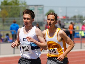 Regiopolis-Notre Dame’s Paul Bates, right, pulls ahead of Kingston Collegiate’s Alex Drover in the last lap to win the junior boys 3,000-metres race at the Kingston Area Secondary Schools Athletic Association track and field championships at CaraCo Field on Thursday.
(Julia McKay/The Whig-Standard)