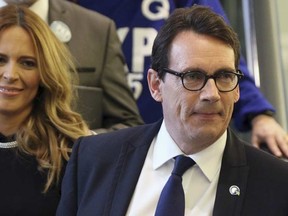 Parti Quebecois candidate for the party leadership Pierre Karl Peladeau (R) arrives with his girlfriend Julie Snyder to a ceremony at the convention center in Quebec City, May 15, 2015. REUTERS/Mathieu Belanger