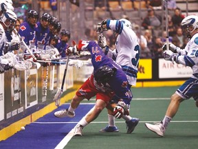 The Rock’s Kevin Ross is knocked down against the Rochester Knighthawks. (MICHAEL PEAKE/Toronto Sun)
