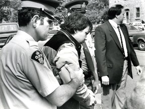 John Lee Jr. is escorted into court on June 5, 1986. (Ian MacAlpine/Whig-Standard file photo)