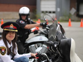 Sophia Nikitopoulos sits on a Kingston Police motorcycle as one of the perks of winning the Chief for the Day contest.