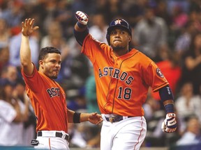 Houston Astros’ Luis Valbuena (right) celebrates with Jose Altuve after hitting a home run last night against the Blue Jays. (USA TODAY SPORTS)