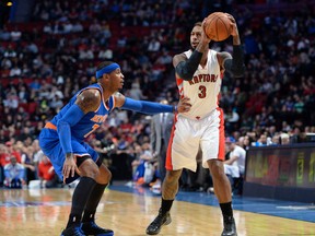 Raptors forward James Johnson (right) prepares to shoot the ball as Knicks forward Carmelo Anthony (left) defends during first quarter NBA preseason action at the Bell Centre in Montreal on Oct. 24, 2014. (Eric Bolte/USA TODAY Sports)