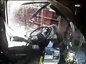 A bus driver is flung from his seat after a collision with a freight train in East Point, Ga., May 13, 2015. (YouTube)