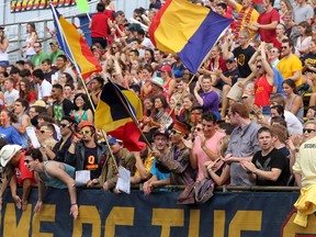 Queen's Golden Gaels fans cheer on their team against the McMaster Marauders in Ontario University Association football action at Richardson Stadium in Kingston.