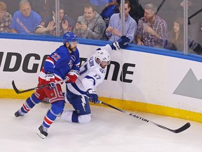 Rangers defenceman Dan Boyle (left) and Lightning centre Alex Killorn (right) battle for the puck during second period action in Game 1 of the Eastern Conference Final in New York on Saturday, May 16, 2015. (Adam Hunger/USA TODAY Sports)