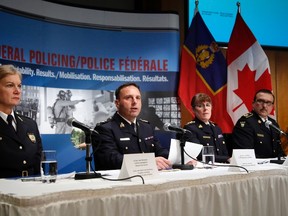 Left to right:  Assistant Superintendent Joan McKenna, Ottawa Police Services; Assistant Commissioner James Malizia, RCMP Federal Policing Operations; Chief Superintendent Jennifer Strachan, RCMP Criminal Operations Office, and Deputy Commissioner Scott Tod, Ontario Provincial Police,  listen to reporters' questions at RCMP headquarters after announcing terror-related charges have been laid against three men in Ottawa, February 3, 2015. Police on arrested an Ottawa man they said was planning to aid Islamic State fighters and charged him with participation in the activity of a terrorist group. (REUTERS/Patrick Doyle)