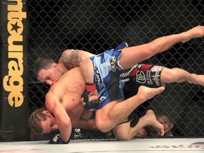 Frankie Edgar "The Answer" (red) of the U.S. and compatriot Urijah Faber "The California Kid" (blue) fight on their featherweight bout during UFC fight night in Manila May 16, 2015. Edgar won by a unanimous decision.    (REUTERS/Romeo Ranoco)