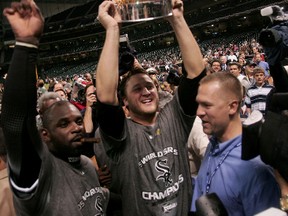 Former White Sox pitcher Mark Buehrle (centre) and Carl Everett celebrate with the World Series championship trophy after beating the Astros in a sweep in 2005. (AFP)