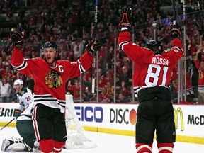 Chicago Blackhawks captain Jonathan Toews and Marian Hossa celebrate Toews' second period goal against the Minnesota Wild in Game Two of the Western Conference Semifinals. (Jonathan Daniel/AFP)