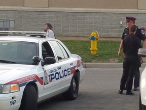 Det.-Const. Jeni Reynolds and Staff Sgt Jeff Dunham in the White Oaks mall parking lot Saturday. NORMAN DEBONO / THE LONDON FREE PRESS