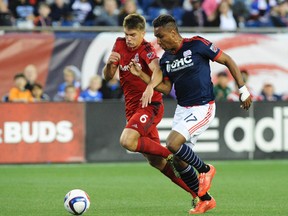 Toronto FC defender Nick Hagglund (left) and New England Revolution forward Juan Agudelo chase after the ball during the first half at Gillette Stadium on Saturday. (USA TODAY SPORTS/PHOTO)