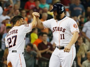 Evan Gattis and Jose Altuve of the Houston Astros celebrate after Gattis hit a two-run home run in the third inning during their game against the Toronto Blue Jays at Minute Maid Park on May 16, 2015 in Houston, Texas. (Scott Halleran/AFP)