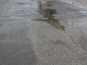 Rain puddles grow on the chilly May long weekend Sunday of 2015. JOYANNE PURSAGA/Winnipeg Sun