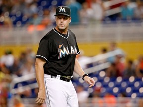 Mike Redmond #11 of the Miami Marlins walks back to the dugout during the eighth inning of the game against the Philadelphia Phillies at Marlins Park on September 23, 2014 in Miami, Florida. (Rob Foldy/Getty Images/AFP)