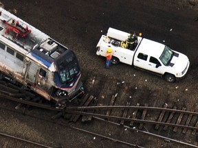 Emergency workers look through the remains of a derailed Amtrak train in Philadelphia, Pa., May 13, 2015. (LUCAS JACKSON/Reuters)