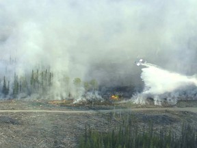 A firefighting airtanker makes a drop on the Little Bobtail Lake Fire located 30 miles (50 kms) east of Prince George, British Columbia, Canada as seen in an undated picture from the B.C. Wildfire Management Branch. The blaze has burned 20,000 hectares (49,41 acres) as of May 16, 2015 and is 20 percent controlled, according to the Wildlife Management Branch.  REUTERS/B.C. Wildfire Management Branch/Handout