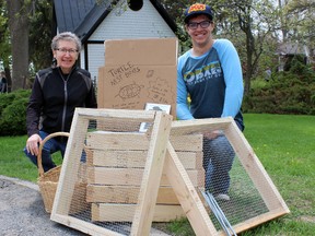 Susan Irving, left, from Turtles Kingston and Mathew Kahansky, from the Society of Conservation Biology at Queen's University, sell turtle nest boxes in Kingston, Ont. on Saturday May 16, 2015. Steph Crosier/Kingston Whig-Standard/Postmedia Network