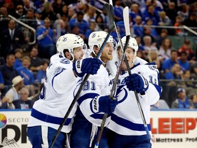 Ondrej Palat #18 celebrates with Steven Stamkos #91, and Nikita Kucherov #86 of the Tampa Bay Lightning after scoring a goal in the third period against the New York Rangers in Game One of the Eastern Conference Finals during the 2015 NHL Stanley Cup Playoffs at Madison Square Garden on May 16, 2015 in New York City.  (Bruce Bennett/Getty Images/AFP)