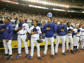 The Montreal Expos stand for the Canadian and U.S. national anthems during the team's final game in Montreal against the Florida Marlins at Olympic Stadium, September 29, 2004. (REUTERS)