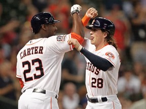 Astros’ Colby Rasmus (right) is congratulated after hitting a home run against his former team, the Blue Jays, on Sunday. (AFP/PHOTO)