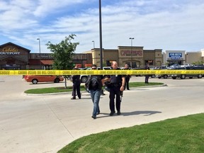 Police escort a man at the scene of a shooting in Waco, Texas, in this handout photo provided by the Waco Police Department on May 17, 2015.  Police in Waco, Texas, said on Sunday that gunfire at a sports bar left a number of people dead and others injured while local media reported that nine people had been killed in a fight between biker gangs. REUTERS/Waco Police Department/Handout