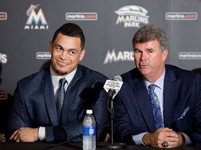 Dan Jennings speaks as Giancarlo Stanton looks on during a press conference at Marlins Park on November 19, 2014 in Miami, Florida.   (Rob Foldy/Getty Images/AFP)