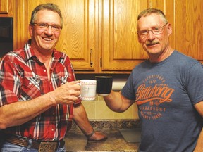 Wildrose candidate Dave Schneider, left, and campaign manager Rod Ruark toast after Schneider unofficially won the Little Bow riding in the May 5 Alberta election. Stephen Tipper Vulcan Advocate