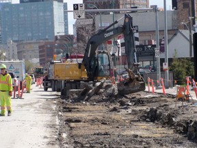 Crews tear up right hand lanes and sidewalks on the north side of Portage Avenue May 15, 2015. Despite calls for more bike lanes in the city, there are no plans to incorporate a cycling lane into the revamped thoroughfare. (TOM BRODBECK/Winnipeg Sun)