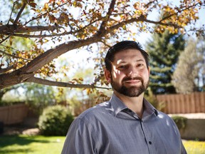 Edmonton Police Cst. Doug McLeod poses for a photo in the backyard of his home  May 18, 2015. McLeod sufffers from post-traumatic stress disorder and has gone through the police service's unique reintegration program for members suffering from PTSD. Ian Kucerak/Edmonton Sun/Postmedia Network
