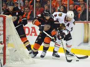 Anaheim Ducks center Andrew Cogliano (7) plays for the puck against Chicago Blackhawks defenseman Duncan Keith (2) during the second period in game one of the Western Conference Final of the 2015 Stanley Cup Playoffs at Honda Center. (Gary A. Vasquez-USA TODAY Sports)