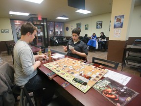 Caleb Rowe, left, and Jose Gonzalez enjoy a game of Arkham Horror at the Cardboard Cafe in London.
The new cafe features access to 400 games for `as long as you want? for a $5 cover. The cafe has patrons as young as six and as old as 70 but its prime demographic is college and university students. (DEREK RUTTAN, The London Free Press)