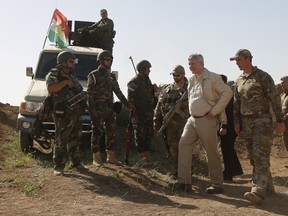 Canada's Prime Minister Stephen Harper visits with Kurdish soldiers. (REUTERS)