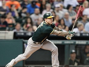 Brett Lawrie of the Oakland Athletics singles to right field in the sixth inning against the Houston Astros at Minute Maid Park on Sunday. (Bob Levey/Getty Images/AFP)