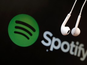 Headphones are seen in front of a logo of online music streaming service Spotify in this illustration picture taken in Strasbourg, February 18, 2014. (REUTERS/Christian Hartmann)