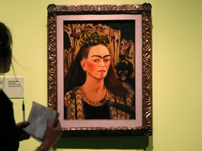 An oil on board painting "Self Portrait with Monkey" by painter Frida Kahlo is viewed during a preview of the exhibit of Kahlo and Mexican muralist Diego Rivera at the Detroit Institute of Arts (DIA) in Detroit, Michigan March 10, 2015. REUTERS/Rebecca Cook