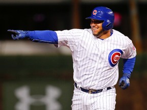 Chicago Cubs catcher Welington Castillo smiles after hitting a two-run homer against the Cincinnati Reds during MLB play at Wrigley Field. (Kamil Krzaczynski/USA TODAY Sports)