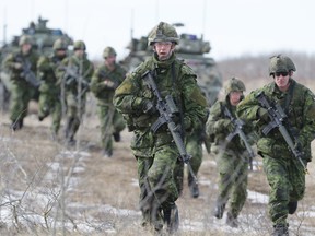 Soldiers of First Battalion, Princess Patricia’s Canadian Light Infantry (1 PPCLI) advance to attack a mock enemy trench during Exercise Patricia Villain earlier this year at CFB Wainwright. (Grant Cree/Postmedia Network file photo)