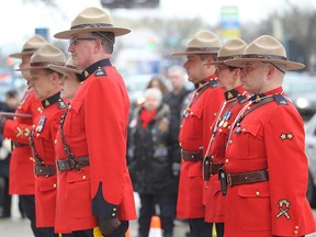 Members of the RCMP pay their respects during a memorial for an officer who was killed in the line of duty in January. One officer threatened and shot at with a firearm Friday in southwestern Manitoba was hit, but has since been released from hospital.(Brian Donogh/Postmedia Network)