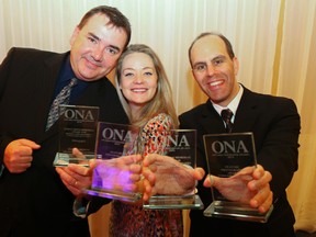Postmedia's Dave Ashton, left, Emily Mountney-Lessard and Luke Hendry hold their 2014 Ontario Newspaper Award finalist trophies at the ceremony in Hamilton, Ont. Saturday, May 16, 2015. Postmedia national content manager Ashton was honoured for his creative design of Hendry's report on a case of suspected Ebola virus disease at Belleville General Hospital. Mountney-Lessard and Hendry each received honours for feature photography in newspapers with circulations less than 25,000 copies. Mountney-Lessard captured bagpipers reflected in a puddle during a Trenton festival; Hendry photographed a boy and his dog playing in the Moira River. Hendry's photo of a Quinte West firefighter at a Stirling-area barn fire also received a nomination. The four nominations were The Intelligencer's best showing in more than a decade. Jerome Lessard/Belleville Intelligencer/Postmedia Network