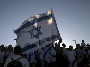 Israelis carry flags during a march marking Jerusalem Day near Damascus Gate outside Jerusalem's Old City May 17, 2015. Israeli police on horseback confronted dozens of Palestinian protesters who threw stones at the forces protecting thousands of flag-waving Jewish nationalists marching on Sunday on the anniversary of Israel's capture of East Jerusalem in a 1967 war. Israel later annexed the area, making it a part of its capital in a move never recognised internationally. REUTERS/Baz Ratner